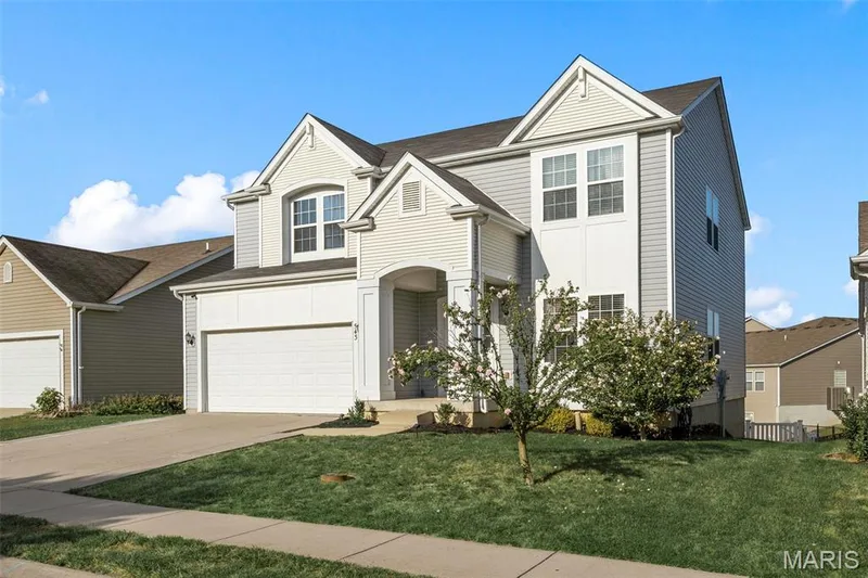 Contemporary residence featuring a two-car garage, multiple gabled rooflines, and a covered entry — 543 Country Chase Drive, Lake St. Louis, MO 63367
