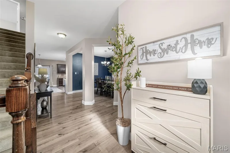 Wood-finish flooring throughout, carpeted staircase, and recessed lighting — 543 Country Chase Drive, Lake St. Louis, MO 63367