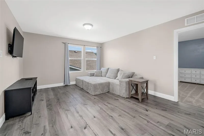 Wood-finish flooring throughout, neutral wall paint, and a ceiling-mounted light fixture — 543 Country Chase Drive, Lake St. Louis, MO 63367
