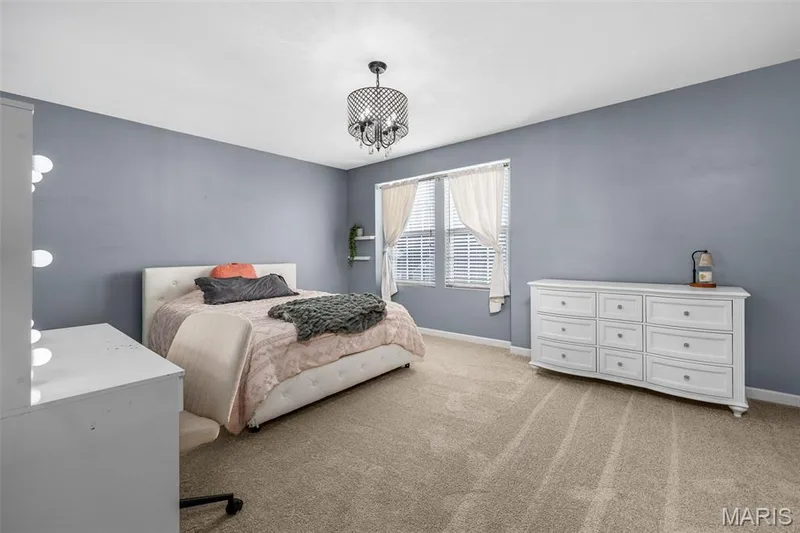 Carpeted room with a multi-pane window, white blinds, and built-in shelving — 543 Country Chase Drive, Lake St. Louis, MO 63367