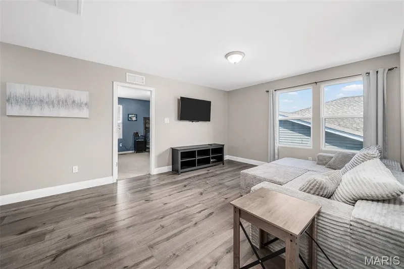 Wood-finish flooring, neutral wall tones, recessed lighting, and white trim accents — 543 Country Chase Drive, Lake St. Louis, MO 63367