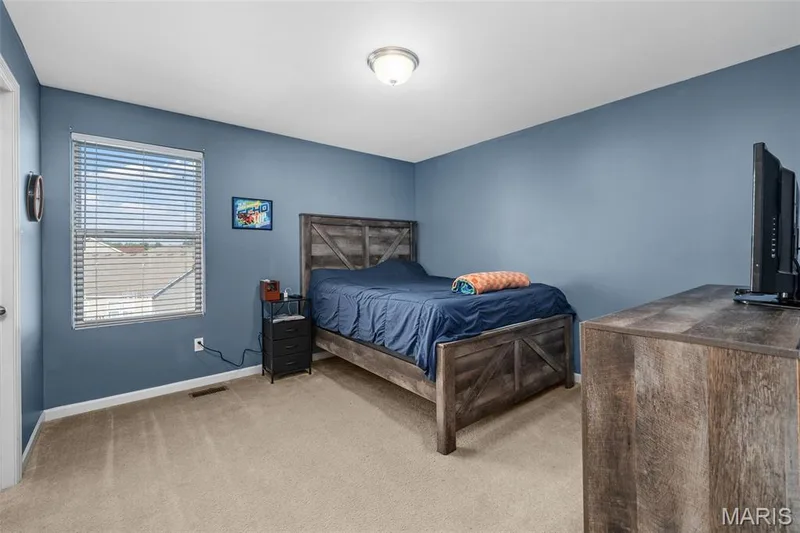 Carpeted flooring, blue painted walls, and a single window with blinds — 543 Country Chase Drive, Lake St. Louis, MO 63367