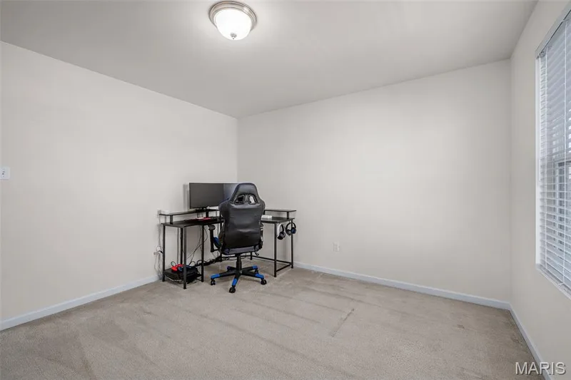 Neutral paint palette and carpeted flooring with a single window featuring blinds — 543 Country Chase Drive, Lake St. Louis, MO 63367