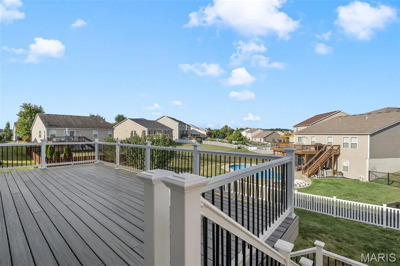 Spacious composite deck with white railings and black balusters — 543 Country Chase Drive, Lake St. Louis, MO 63367