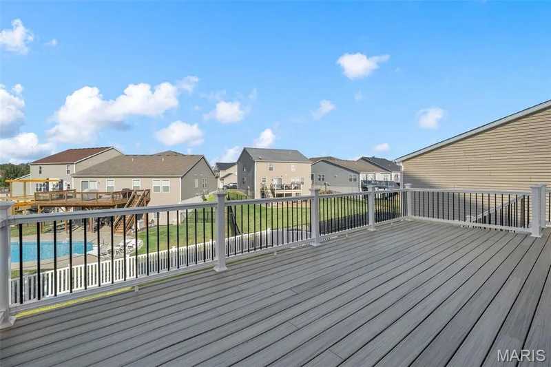 Spacious elevated deck with composite decking and white railing with black spindles — 543 Country Chase Drive, Lake St. Louis, MO 63367
