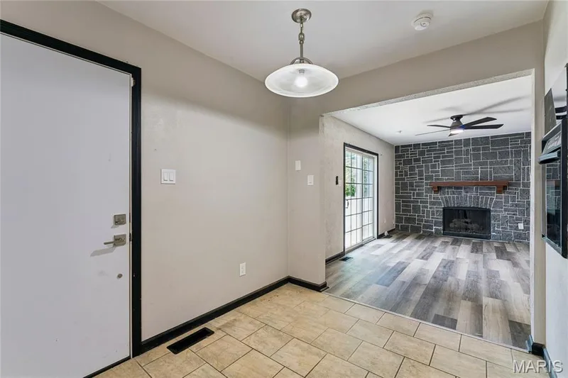 Tiled entry flooring with an overhead semi-flush mount light fixture — 2801 Droste Road, St Charles, MO 63301