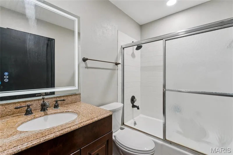 Vanity with speckled countertop, oval basin, and dark bronze-finish fixtures — 2801 Droste Road, St Charles, MO 63301
