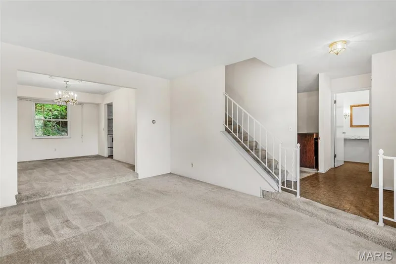 Two-story interior with neutral carpeting and white walls — 1192 Cantina Drive, Chesterfield, MO 63141
