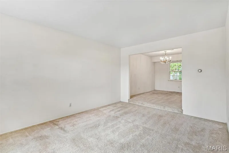 Carpeted flooring throughout, with a step-up to large dining room. — 1192 Cantina Drive, Chesterfield, MO 63141