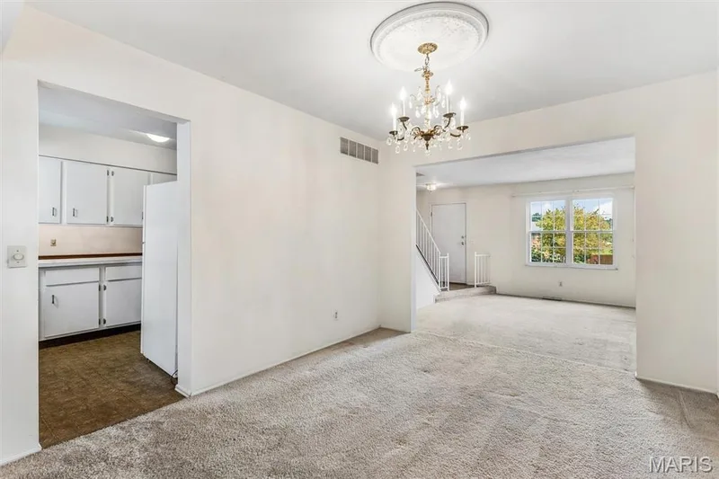 Dining room opens to living room and kitchen, perfect for entertaining — 1192 Cantina Drive, Chesterfield, MO 63141