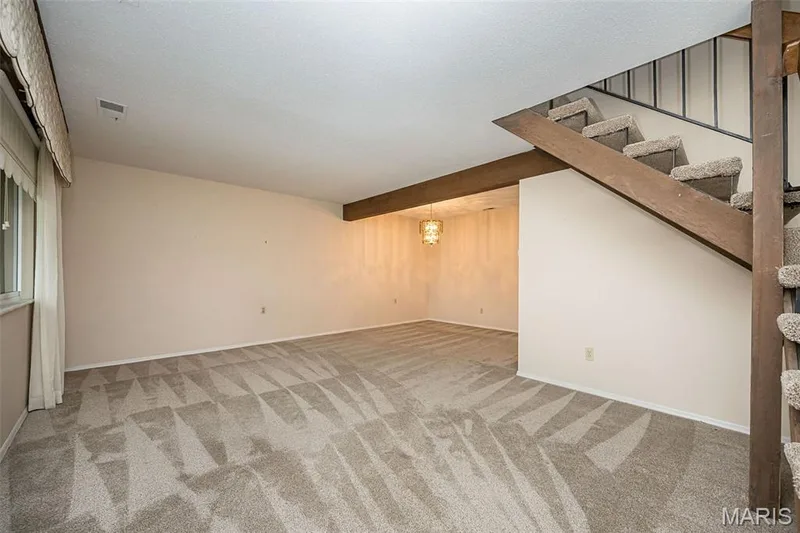 Spacious living room flows into a dining space. — 1368 Hampton Road #A, St Charles, MO 63303