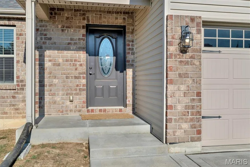 Brick and siding exterior with a covered porch — 56 Huntleigh Park Court, Wentzville, MO 63385