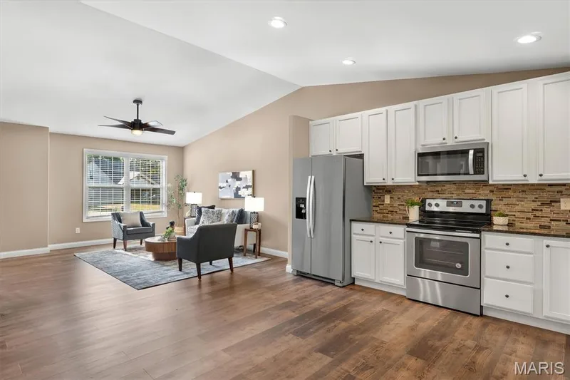 Wood-finish flooring throughout, vaulted ceiling, and recessed lighting — 56 Huntleigh Park Court, Wentzville, MO 63385