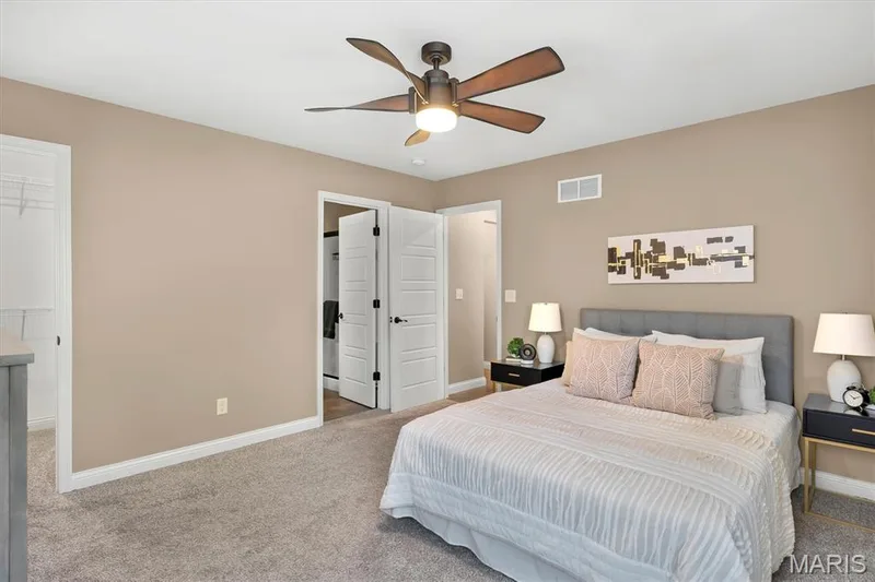 Neutral wall color, ceiling fan, carpet flooring, and white trim — 56 Huntleigh Park Court, Wentzville, MO 63385