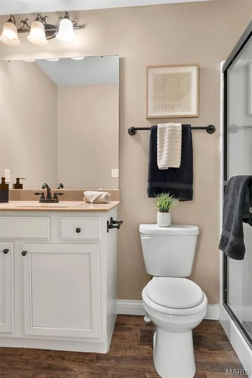 White vanity with dark hardware, a tan countertop, and an undermount sink — 56 Huntleigh Park Court, Wentzville, MO 63385