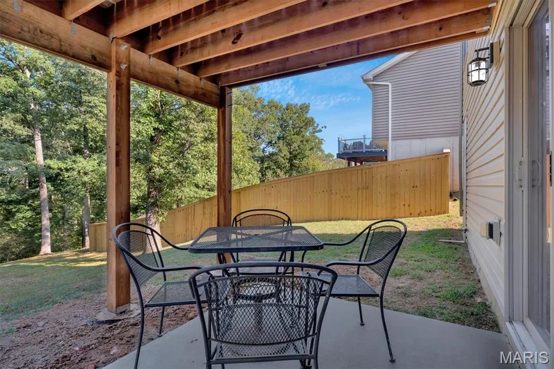 Covered patio featuring a concrete surface and exposed wood joists — 56 Huntleigh Park Court, Wentzville, MO 63385