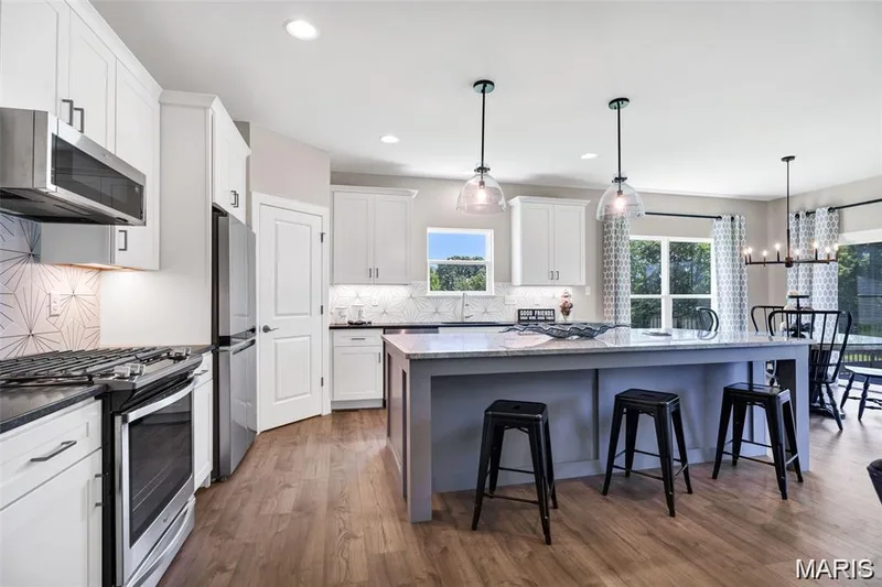 Beautiful kitchen with large center island.  Photo from a previously completed home. — 1 Grand Columbia, O'Fallon, MO 63366