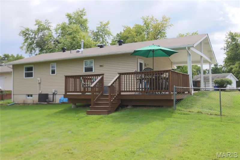 Expansive backyard featuring a newly stained wood deck with stairs and a  fenced backyard. — 3 Oxbow Road, St Peters, MO 63376