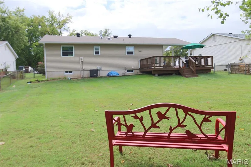 Expansive grass lawn with a wood deck and plenty of room for playing games or add that pool you've always wanted to have. — 3 Oxbow Road, St Peters, MO 63376