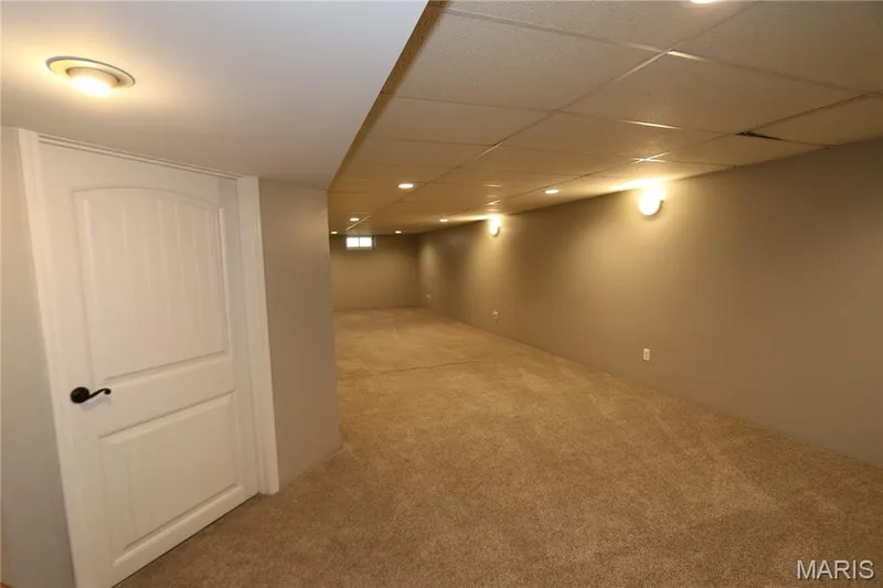 View from base of steps. Recessed lighting, wall sconces, neutral wall finish, carpet flooring, egress window — 3 Oxbow Road, St Peters, MO 63376