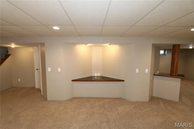 Recessed lighting with dimmers, drop ceiling, built-in shelving, carpet flooring, and a built-in bar or television stand, you decide. — 3 Oxbow Road, St Peters, MO 63376