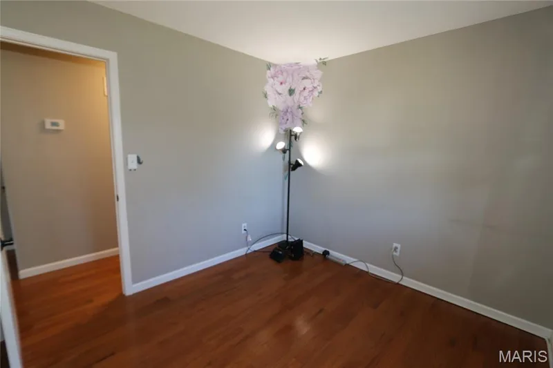 #3 Bedroom - view from closet doors. Hardwood flooring throughout with light gray wall paint — 3 Oxbow Road, St Peters, MO 63376