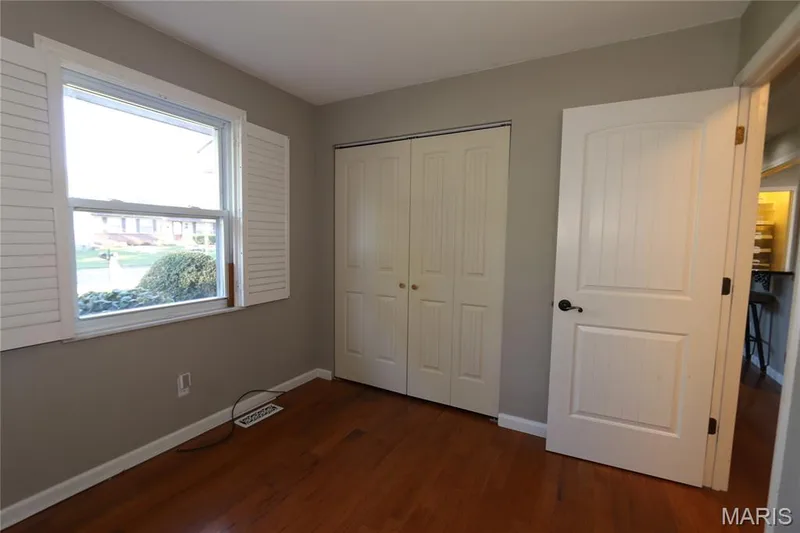 #3 Bedroom - view from flowered corner with shutters open on sides. Hardwood-style flooring throughout — 3 Oxbow Road, St Peters, MO 63376
