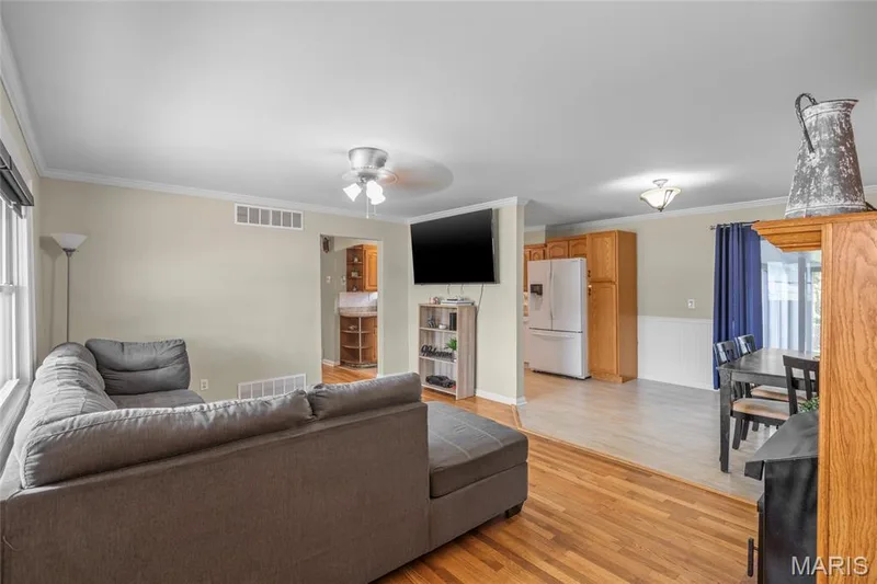 Hardwood-style flooring, white trim, recessed lighting, and a ceiling fan — 712 Highland Drive, O'Fallon, MO 63366