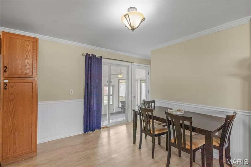 Wood-finish flooring with white wainscoting and crown molding — 712 Highland Drive, O'Fallon, MO 63366
