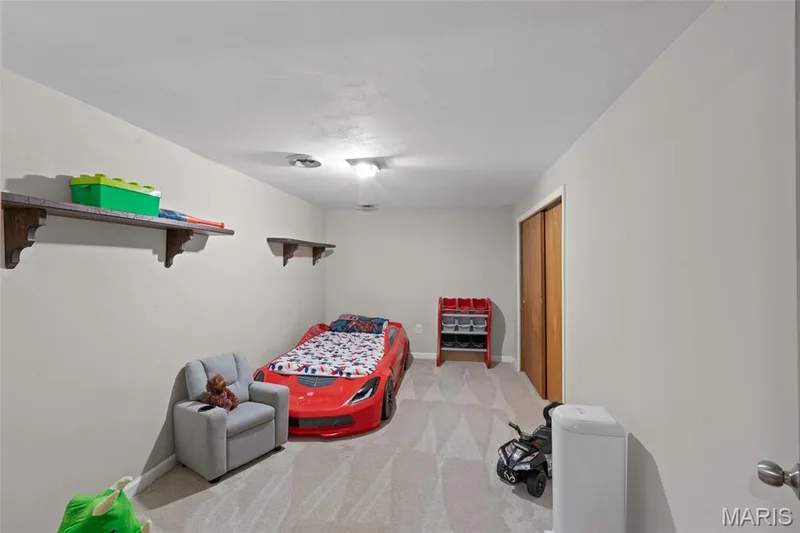 Recessed lighting illuminates neutral-toned walls and patterned carpeting — 712 Highland Drive, O'Fallon, MO 63366