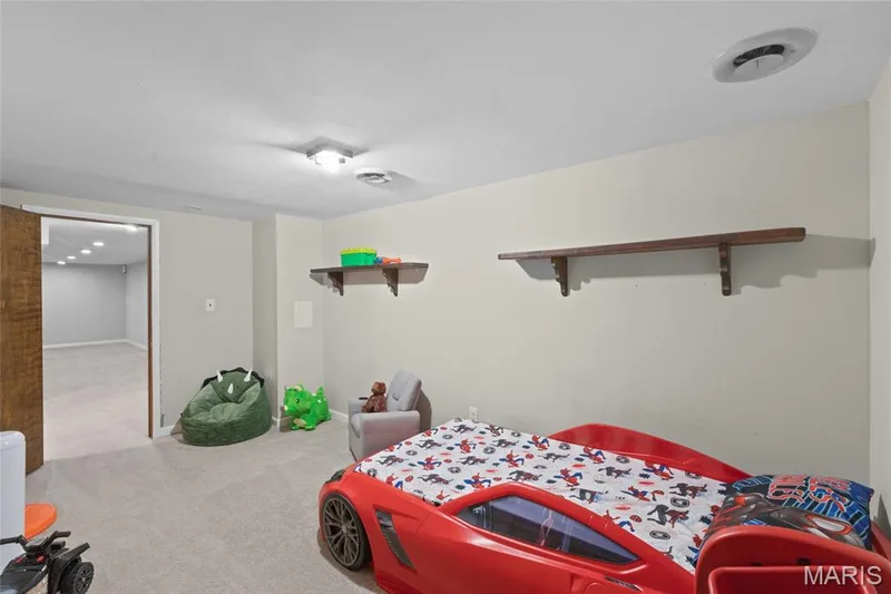 Recessed lighting, flush mount lighting, and wood-finish shelving complement the light-toned walls and neutral carpeting — 712 Highland Drive, O'Fallon, MO 63366