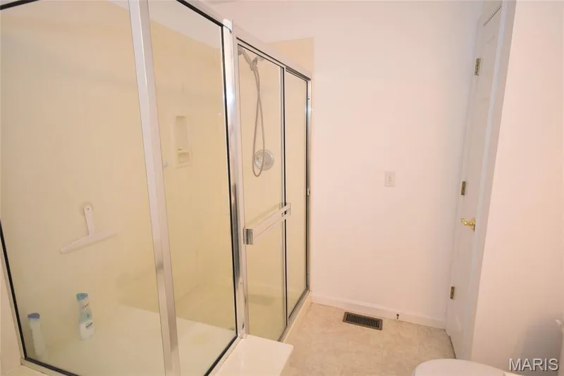 Enclosed shower with clear glass panels and a showerhead fixture — 1129 Piepers Glen Lane #8A, O'Fallon, MO 63366