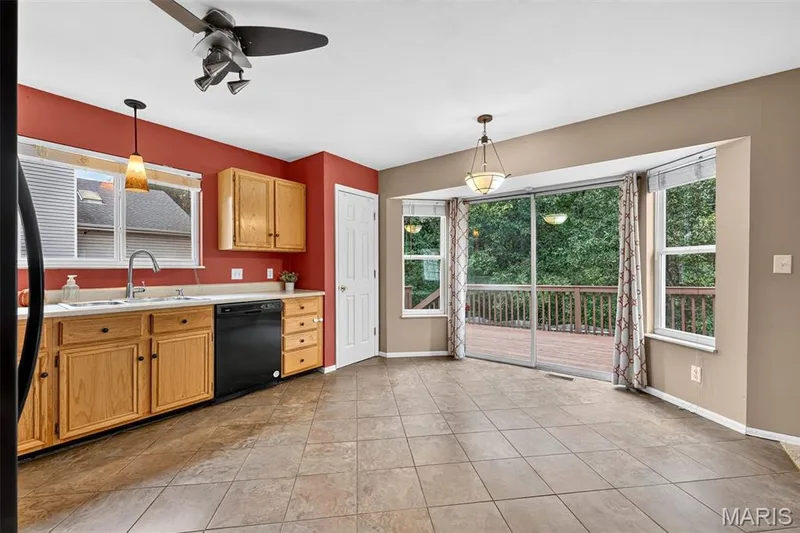 The kitchen provides plenty of cabinets, counter space, and that white door is a wonderful pantry! — 1033 Providence Pointe Drive, Wentzville, MO 63385