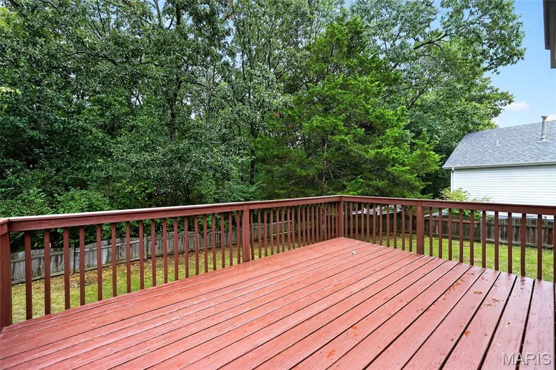 There is a deck that overlooks the trees. — 1033 Providence Pointe Drive, Wentzville, MO 63385