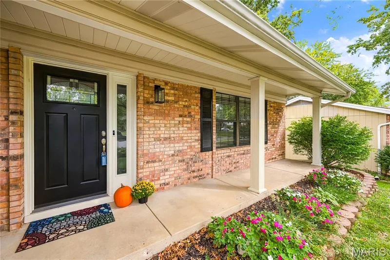 Full Length Covered Porch with Brick & Professional Landscaping! Note the Enclosed Soffits & Gutters with Gutter Guards! — 27 Oak Valley Drive, St Peters, MO 63376