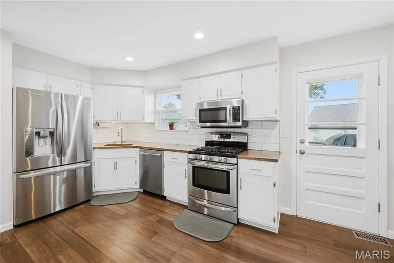 Charming Corner Sink with Designer Faucet, White Subway Tile Backsplash, 5 Burner Gas Stove, Overhead Microwave & French Door Refrigerator stays! — 27 Oak Valley Drive, St Peters, MO 63376