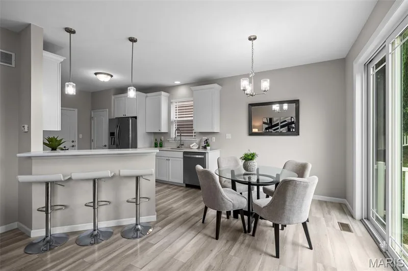 Kitchen has white soft-close cabinets and stainless steel appliances — 17 Rydal Place, St Charles, MO 63303