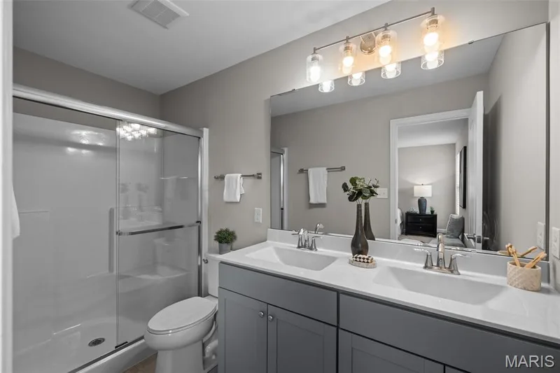 primary en-suite bathroom with a double vanity — 17 Rydal Place, St Charles, MO 63303