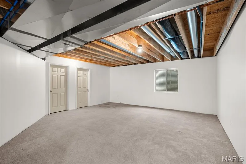 Finished section of the basement with an egress window. — 17 Rydal Place, St Charles, MO 63303