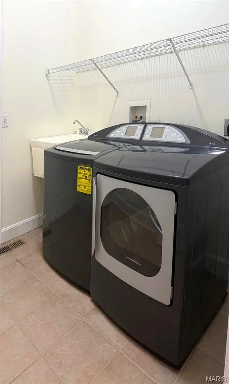 Main floor laundry off kitchen — 213 Woodland Place Court, St Charles, MO 63303