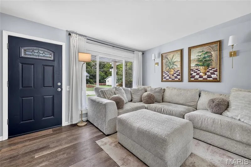 Living room with a wide front picture window and luxury vinyl flooring — 34 Highland Drive, St Charles, MO 63303