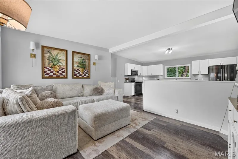 Living room opens to the kitchen over a half wall — 34 Highland Drive, St Charles, MO 63303