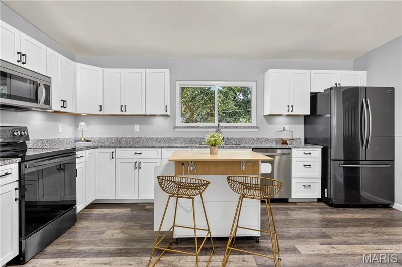 Kitchen with white shaker cabinets, granite countertops, and under-cabinet lighting — 34 Highland Drive, St Charles, MO 63303