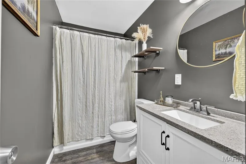 Updated bathroom with a granite vanity top and tub and shower combination — 34 Highland Drive, St Charles, MO 63303