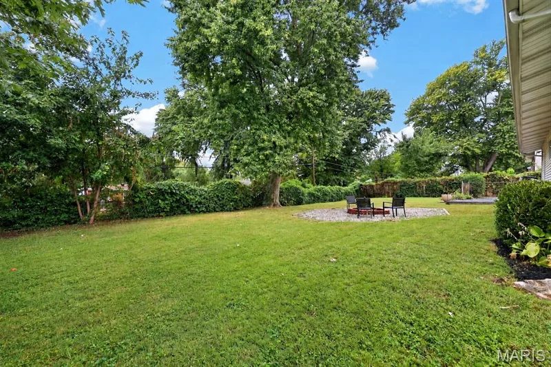 Level backyard screened by established hedges — 34 Highland Drive, St Charles, MO 63303