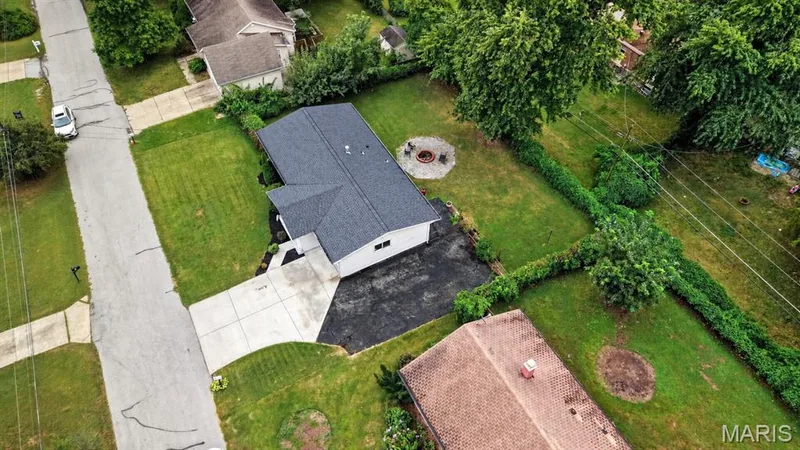 Aerial view of the driveway, side parking pad, and backyard — 34 Highland Drive, St Charles, MO 63303