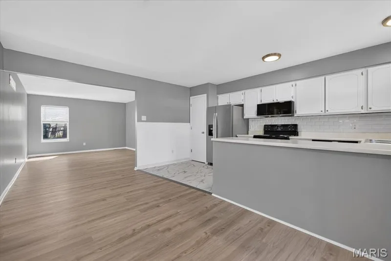 This view from the breakfast area highlights the open floor plan — 885 Delray Drive #H, St Peters, MO 63376