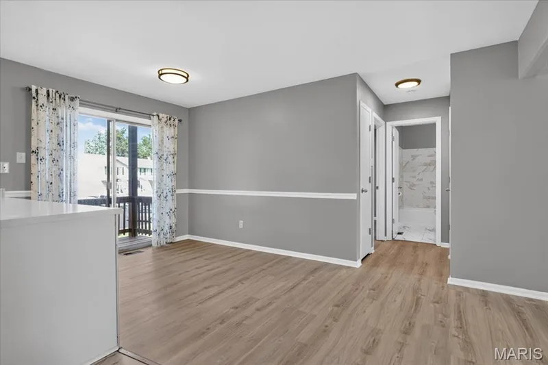 Hall off breakfast area leads to beds & bath — 885 Delray Drive #H, St Peters, MO 63376