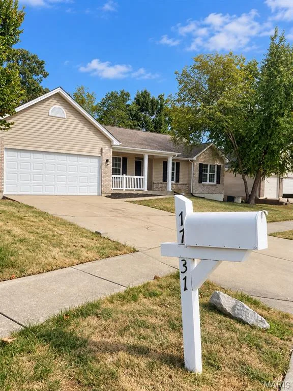 Single-story residence featuring light-colored siding and stone accents — 1731 Fairview Farms Circle, Wentzville, MO 63385
