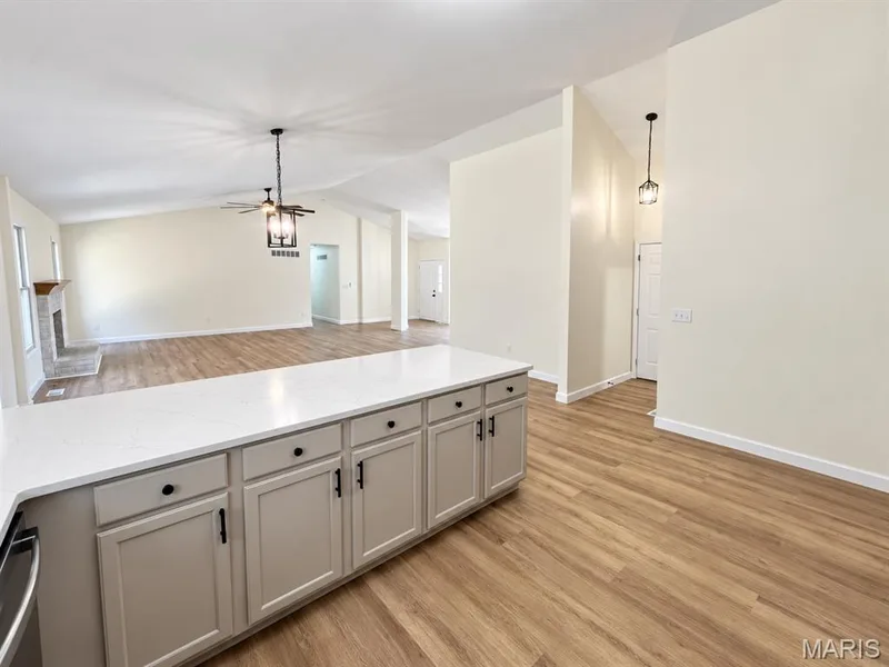 Kitchen island with quartz countertop and shaker-style cabinetry — 1731 Fairview Farms Circle, Wentzville, MO 63385